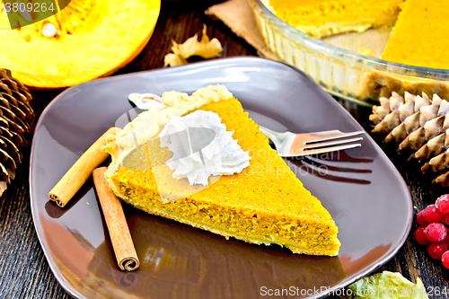 Image of Pie pumpkin in plate with whipped cream on board