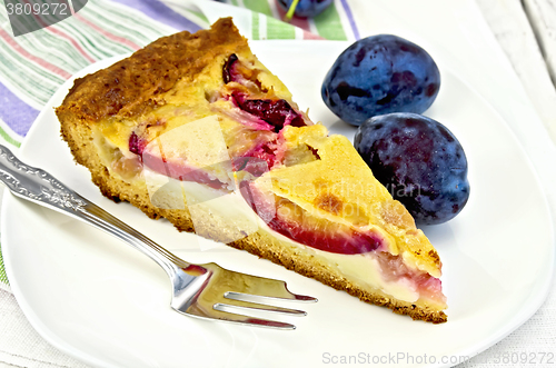 Image of Pie plum with sour cream in white plate on board