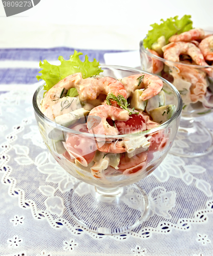 Image of Salad with shrimp and tomatoes in glass on white napkin