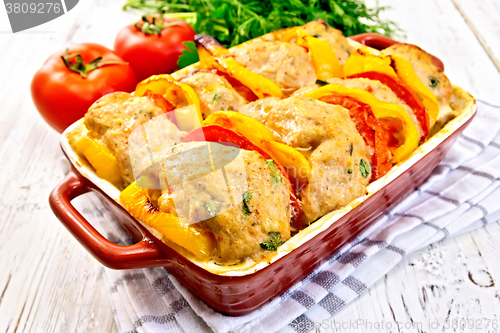 Image of Cutlets of turkey with peppers in pan on board