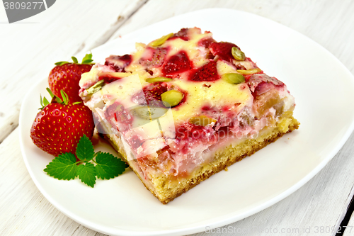 Image of Pie strawberry-rhubarb with sour cream and berries on light boar