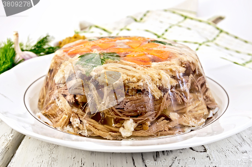 Image of Jellied in big plate with parsley and carrots on board