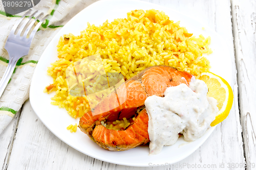 Image of Salmon with lemon and rice on light board