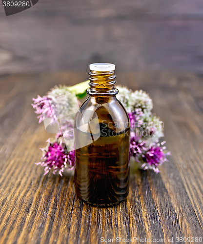 Image of Oil with burdock in vial on board