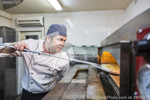 Image of Chef Cooking Pizza