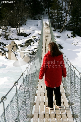 Image of Woman on suspension bridge