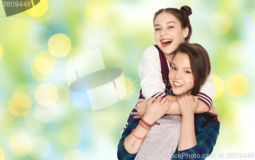 Image of happy smiling pretty teenage girls hugging