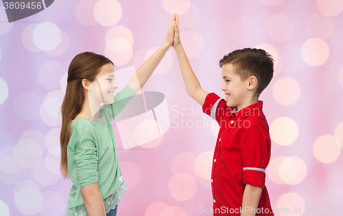 Image of happy boy and girl making high five