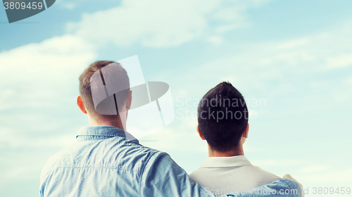 Image of close up of happy male gay couple hugging