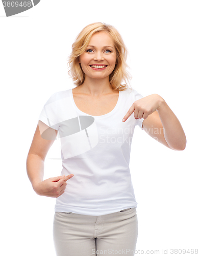 Image of smiling woman in white t-shirt pointing to herself