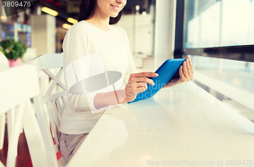 Image of close up of woman with tablet pc at cafe