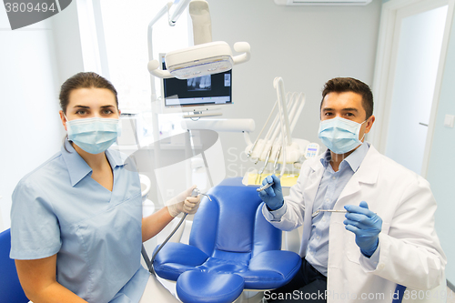 Image of close up of dentist and assistant at dental clinic