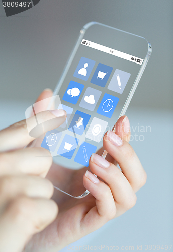 Image of close up of woman with app icons on smartphone