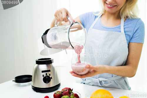 Image of close up of woman with blender and shake at home