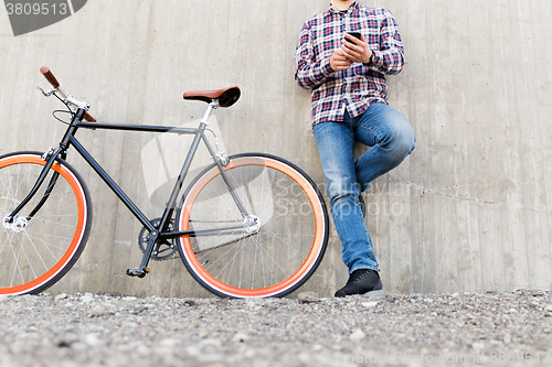 Image of close up of hipster man with smartphone and bike