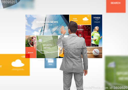 Image of businessman with virtual projection of news pages