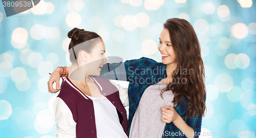 Image of happy smiling pretty teenage girls hugging