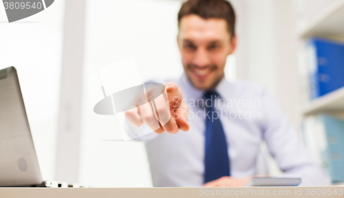 Image of smiling businessman pointing on you in office