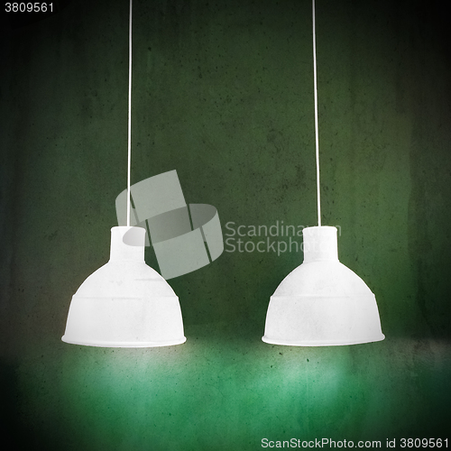 Image of White lamps on green grungy background