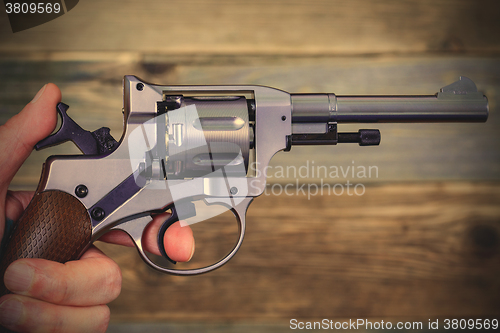 Image of human hand with revolver