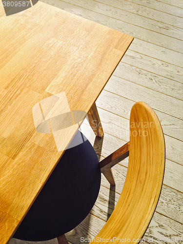 Image of Wooden table and stylish chair