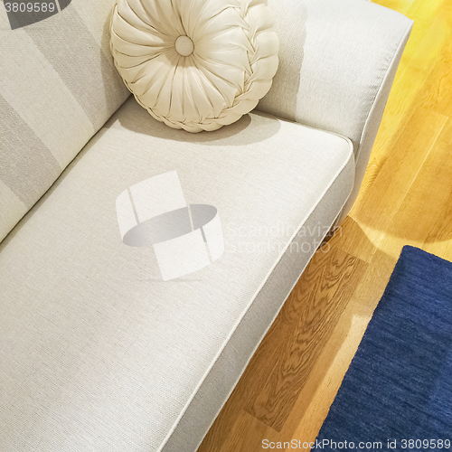 Image of White sofa with a fancy cushion