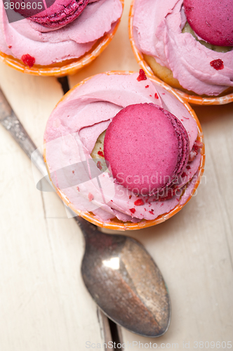 Image of pink berry cream cupcake with macaroon on top