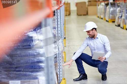 Image of happy businessman with tablet pc at warehouse