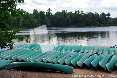 Image of Canoes on lake shore