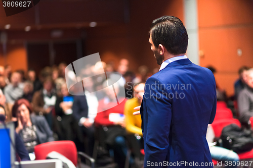 Image of Public speaker giving talk at Business Event.