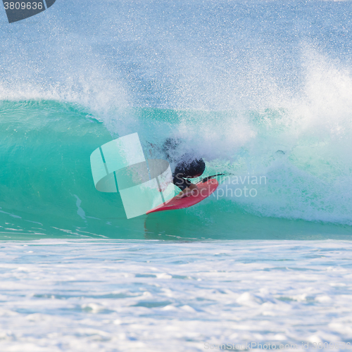 Image of Surfer riding a perfect wave.