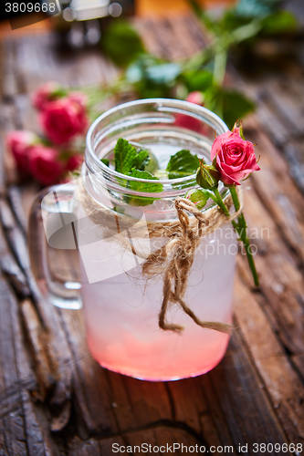 Image of fresh mojito on a rustic table.
