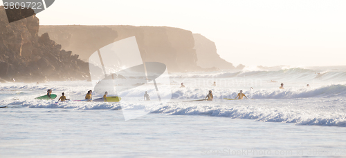 Image of Surfers surfing on El Cotillo beach, Fuerteventura, Canary Islands, Spain.