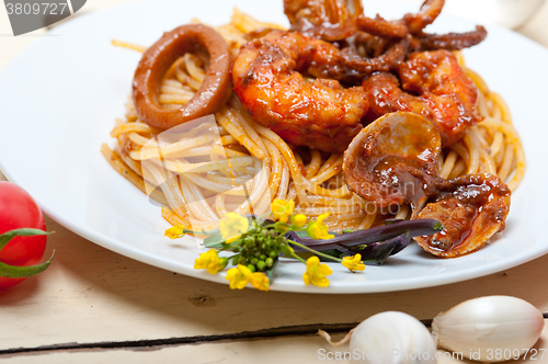 Image of Italian seafood spaghetti pasta on red tomato sauce 