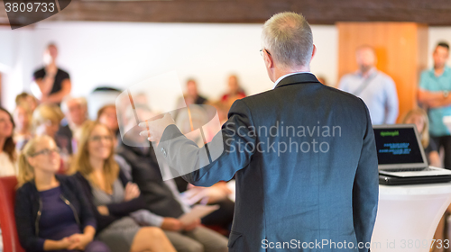 Image of Speaker at Business Conference and Presentation.