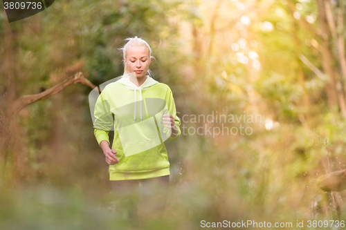 Image of Pretty young girl runner in the forest. 