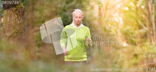 Image of Pretty young girl runner in the forest. 