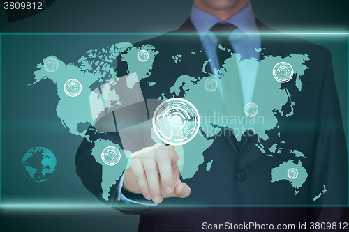 Image of business, technology, internet and networking concept - businessman pressing button with contact on virtual screens. World map