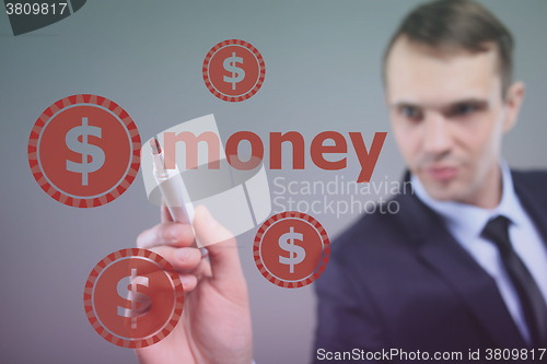 Image of Businessman writing  Money with marker on transparent wipe board. dollar sign
