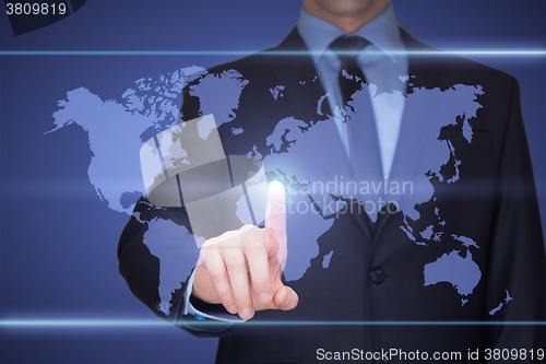 Image of business, technology, internet and networking concept - businessman pressing button with contact on virtual screens. World map