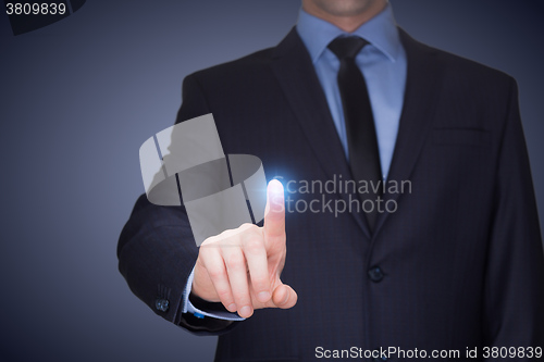 Image of business, technology, internet and networking concept - businessman pressing button with contact on virtual screens. 