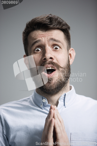 Image of Man is looking imploring over gray background