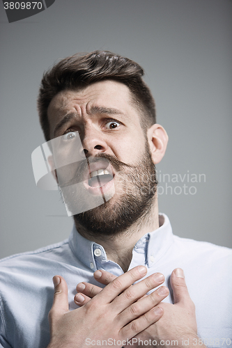 Image of Man is looking imploring over gray background