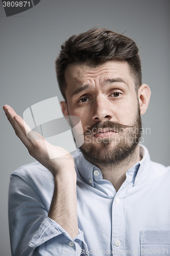 Image of Man is looking bored. Over gray background