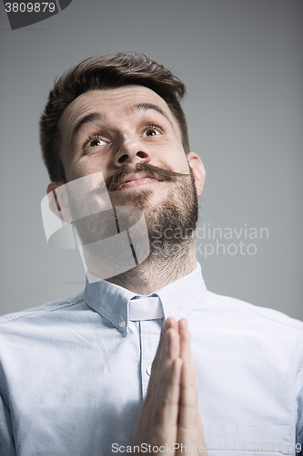 Image of Man is looking imploring over gray background