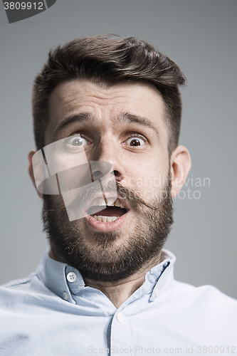 Image of Man is looking scared. Over gray background