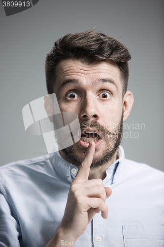 Image of Man is looking scared. Over gray background