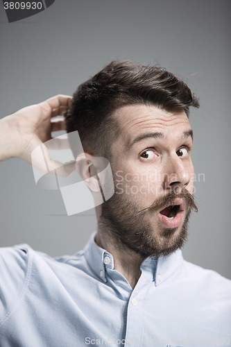 Image of Portrait of young man with shocked facial expression