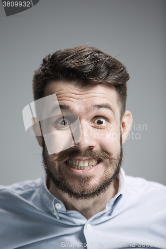 Image of Man is looking scared. Over gray background