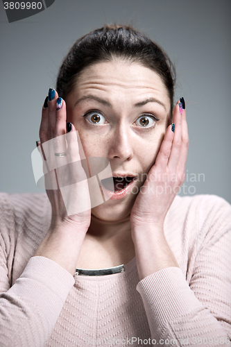 Image of Portrait of young woman with shocked facial expression